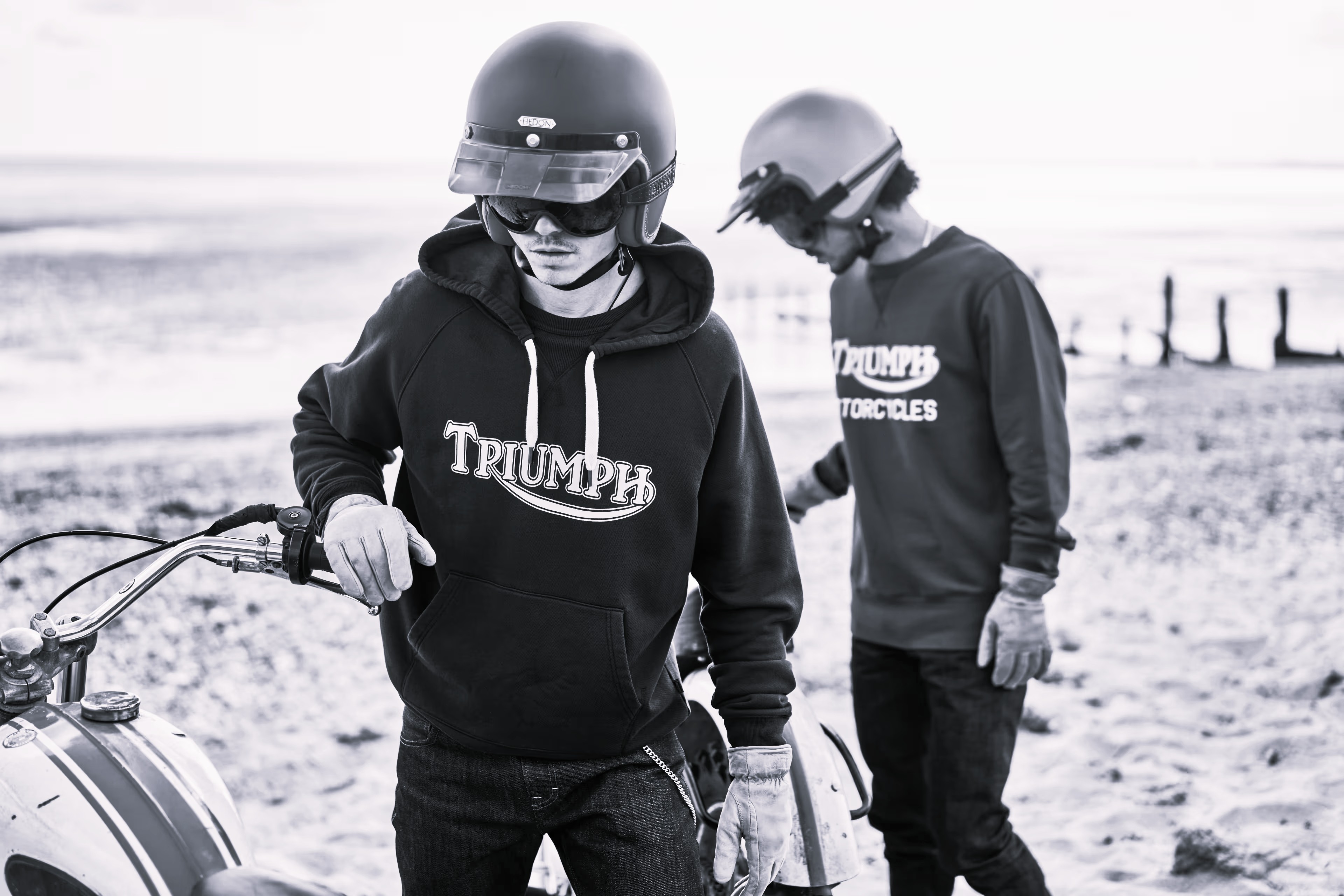 Two men stood outside wearing a triumph motorcycles hoodies