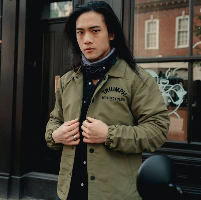 Man wearing a khaki green Triumph Motorcycles jacket